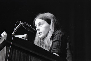 Bernadette Devlin McAliskey at the podium during a talk at Northeastern University