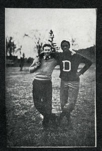 Unidentified student standing arm in arm with football coach Mathew W. Bullock