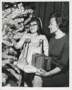 Marie Lucien and client Yvonne Crespo admiring Christmas tree