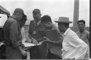 American advisor discussing plan with village chief; Long An.