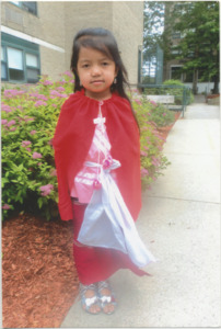 A photograph of So Meh's daughter in traditonal Karenni clothing at Riverplace in Lowell, Massachusetts, 2013