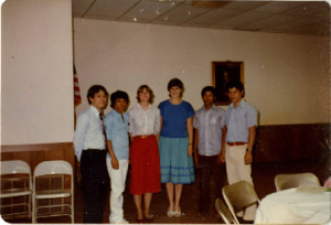 Photograph of a group of men and women standing together, [1982-1983].