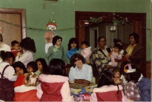 Photograph of a group of adults and children at a Christmas and New Year celebration, [1982-1983].