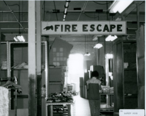Photograph of a "Fire Escape" sign, [1982-1983].