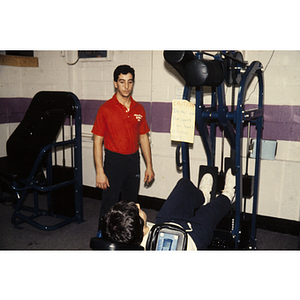 Man works out on an exercise machine in a gym