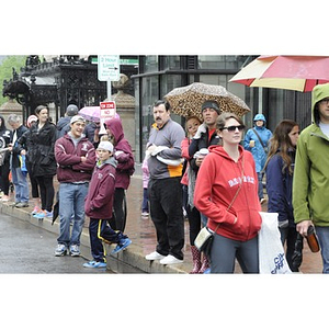 Families and other spectators watch "One Run" runners in Copley Square