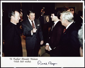 Fr. Monan, Pres. Reagan, Doug Flutie, and ___. Photo is signed by Ronald Reagan: "To Father Donald Monan. With best wishes, Ronald Reagan"