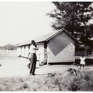 A man bugles in front of a cabin at Breezy Meadows Camp