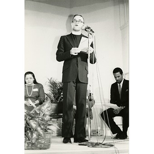 Pastor at the microphone on stage at the Jorge Hernandez Cultural Center.