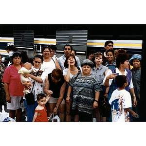 Villa Victoria residents and Inquilinos Boricuas en Acción staff gather together beside a bus.