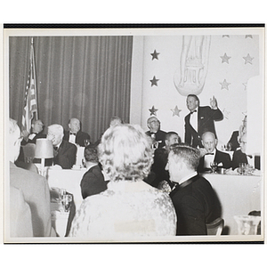 William J. Lynch getting up from a chair while other people look on at the Boys' Clubs of America National Convention in Washington D.C., 1964