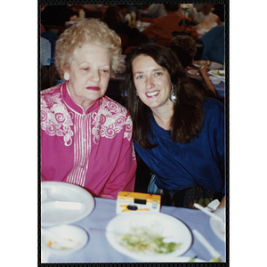 A woman smiles for the camera, sitting with an older woman at a Boys & Girls Club Awards Night