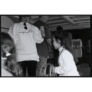 A girl playing ring toss at the Boys and Girls Clubs of Boston 100th Anniversary Celebration Street Fair