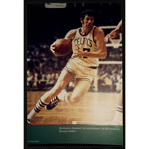 A photograph of an image of the Boston Celtics' John Havlicek at the New England Sports Museum. The image's caption reads, "Havlicek is dwarfed, but not stopped, by Milwaukee's Kareem Jabbar"