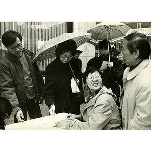 Four Asian Americans in Chinatown hear about bilingual education programs