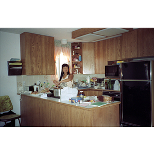 Woman cooking on a Chinese Progressive Association trip to Vancouver