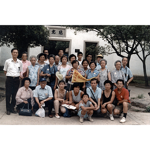 Association members gather for a group photograph in a courtyard while touring China
