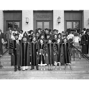 A group of graduates stand together during the School of Law commencement