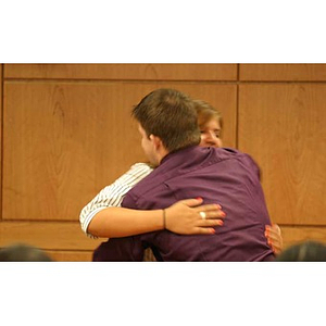 Nadia Alvarez hugs Joseph Bordieri at the Torch Scholars dinner