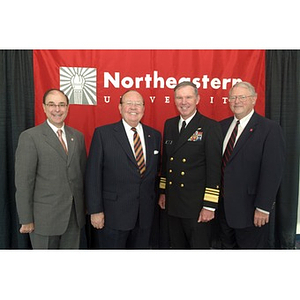 Four men pose together at the Veterans Memorial dedication ceremony