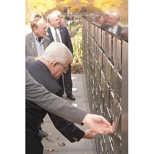 Several men look at the Veterans Memorial at the dedication ceremony