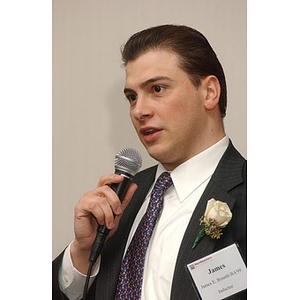 James Bonetti holds a microphone at The National Council Dinner