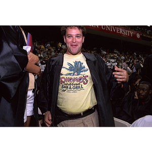 Class of 1994 graduate wearing a "Kokomo's Caribbean Bar and Grill" t-shirt under his graduation robes at the commencement ceremony