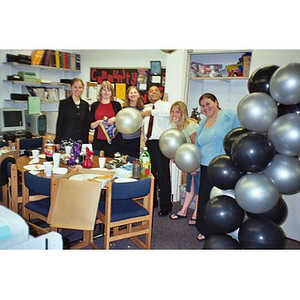 Six Northeastern employees at an office pizza party