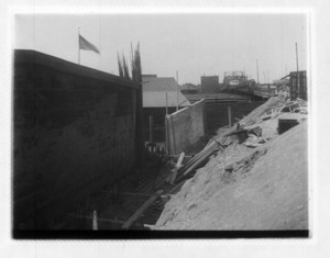 View of construction site between a wall and mound of dirt