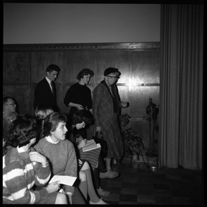 Eleanor Roosevelt (front) walking to the Student Union Ballroom stage for her Distinguished Visitors Program lecture, followed by DVP Committe chair Gail Osbaldeston ('61, seated) and Donald Croteau ('61)