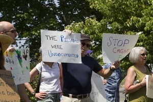 Pro-immigration protesters and signs outside the Chatham town offices building, one with sign reading 'The Pilgrims were undocumented' : taken at the 'Families Belong Together' protest against the Trump administration's immigration policies