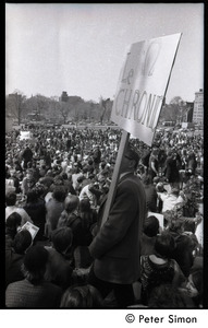 Resistance on the Boston Common: shot of crowd of antiwar demonstrators, with man holding large sign with Resistance symbol and reading 'Le chronic'