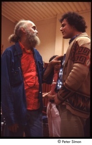 Ram Dass speaking with a man after a lecture at Boston University