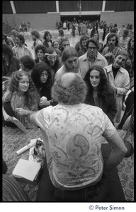 Audience members at the College of Marin gathered in front of the stage to speak to Ram Dass