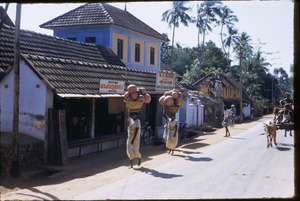 Women carrying clay pots