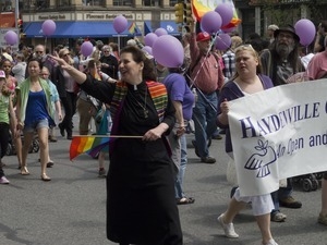Minister from Haydenville and marchers during the Pride Parade; Main Street, Northampton, Mass.