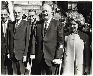 An unidentified man with US Speaker of the House John McCormack, Massachusetts Attorney General Eddie McCormack, Mayor John F. Collins and Mary Collins standing outside