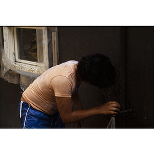 Child getting a drink from a faucet