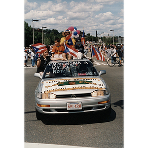 A car drives down Columbus Avenue, Roxbury, during the Festival Puertorriqueño parade