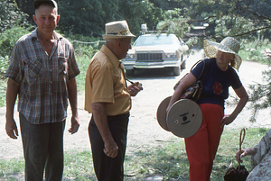 Arthur G. Rosenburg (left), Harvey Cummings, and Mabel Cummings (right) at Moon Barn Raising at entrance to Hopkins Forest on 2 August 1975.