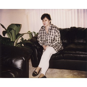 Woman sitting on a leather couch.