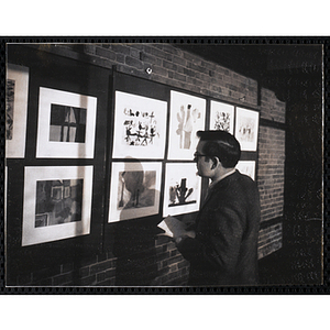 Art instructor Leon Moreau views the Boys' Clubs of Boston Tri-Club Art Exhibit at the Museum of Science