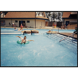 A girl rides in an intertube in a Water Country water park swimming pool during a Tri-Club field trip