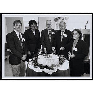 From left to right, Jerry Steimel, Linda Whitlock, Edmund Ansin, Ronald M. Ansin, and Myra Kraft, pose with a cake that reads "Thank You Ansin Family" at the opening of Ansin Youth Center