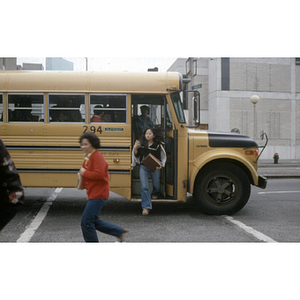 Women exit a bus on the street in Boston