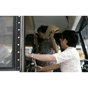 Suzanne Lee addresses people on a bus