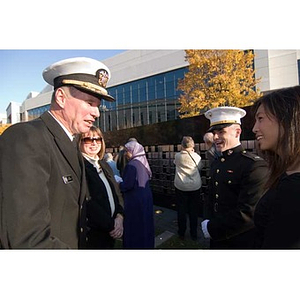 Vice Admiral Mark Fitzgerald speaks to a woman at the Veterans Memorial dedication