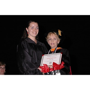 Dean Carole Kenner presents a student with a Nursing Excellence Award during convocation