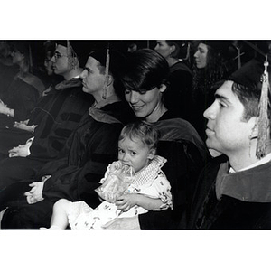 Graduate, Alexa Mortenson, holding Allawra Cox during the School of Law commencement ceremony