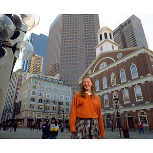 A young woman on co-op standing outside Faneuil Hall